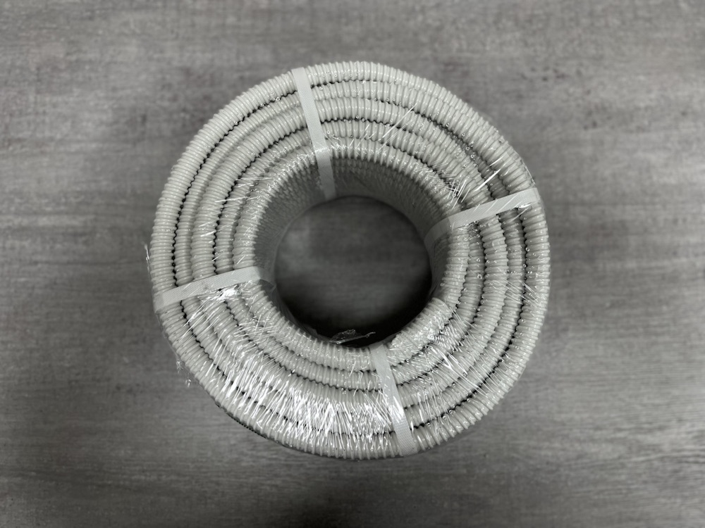 Grey spiral PVC hose coil, top view